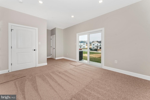 carpeted empty room with recessed lighting and baseboards