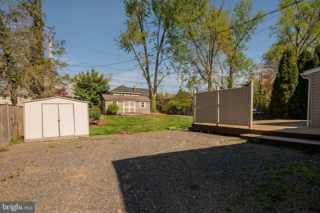 1211 Crestover Rd, Wilmington, DE 19803 - view of yard with fence, a storage unit, an outbuilding, and a deck