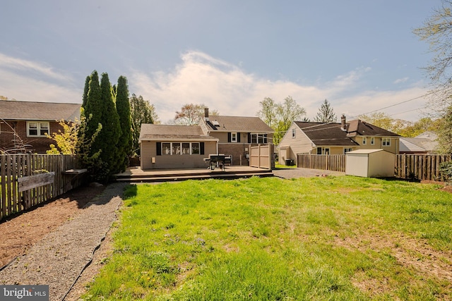 1211 Crestover Rd, Wilmington, DE 19803 - rear view of house with a storage shed, a wooden deck, a fenced backyard, a lawn, and an outdoor structure