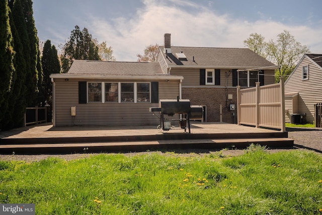 1211 Crestover Rd, Wilmington, DE 19803 - rear view of house with brick siding, central AC, a chimney, and a deck
