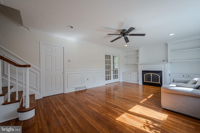 1211 Crestover Rd, Wilmington, DE 19803 - unfurnished living room featuring a fireplace, built in shelves, stairs, wood finished floors, and visible vents