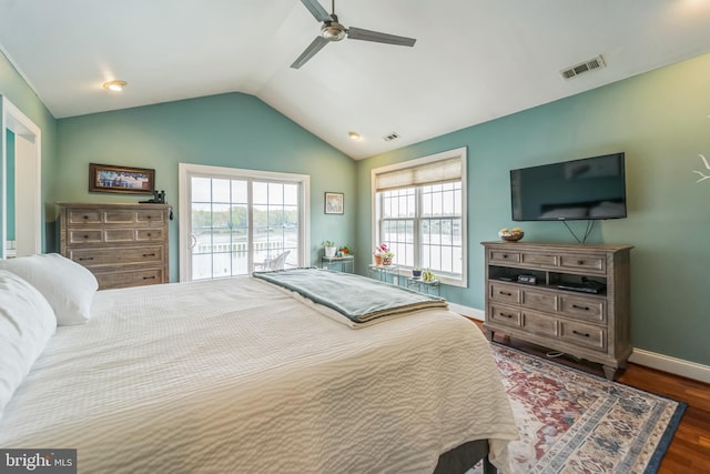 bedroom featuring lofted ceiling, wood finished floors, visible vents, ceiling fan, and baseboards