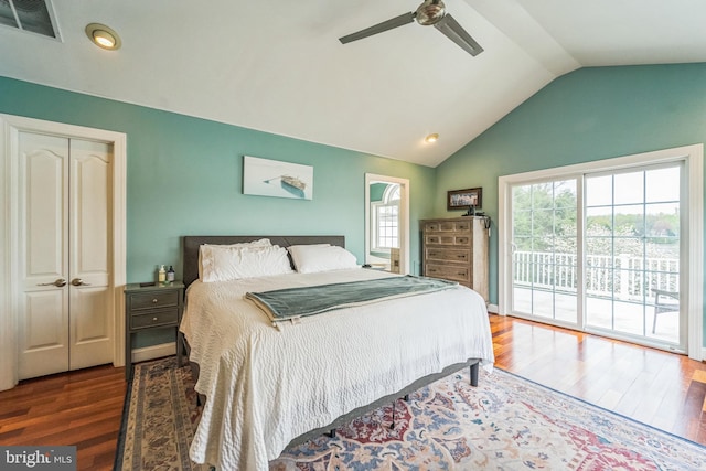 bedroom featuring lofted ceiling, wood finished floors, visible vents, a ceiling fan, and access to exterior