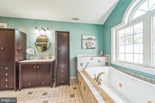 full bathroom with a jetted tub, visible vents, tile patterned flooring, lofted ceiling, and vanity