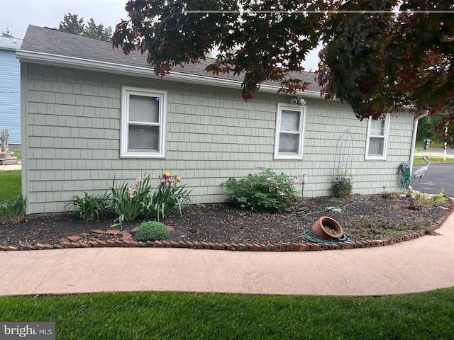 view of property exterior featuring roof with shingles