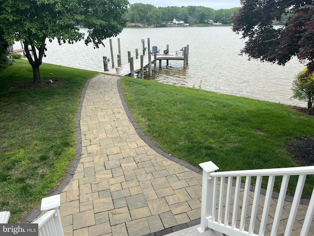 dock area featuring a yard and a water view