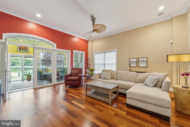 living area featuring ornamental molding, recessed lighting, a healthy amount of sunlight, and wood finished floors