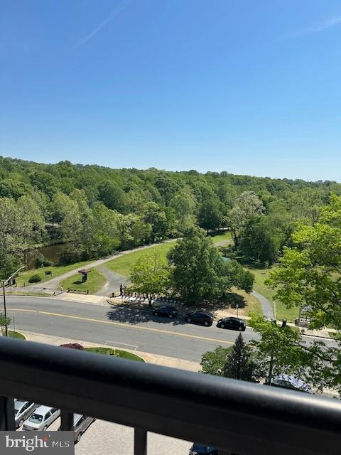birds eye view of property featuring a wooded view