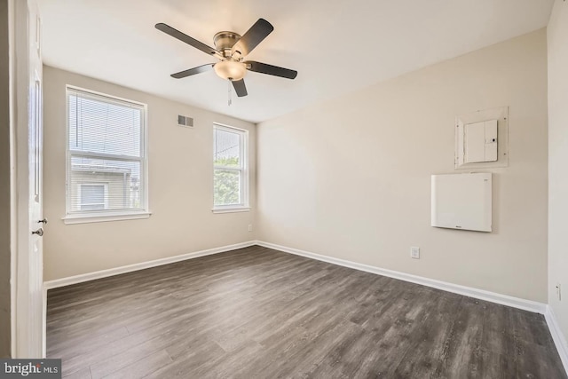 2024 E Baltimore St E, Baltimore, MD 21231 - unfurnished room featuring dark wood-style flooring, ceiling fan, baseboards, and electric panel