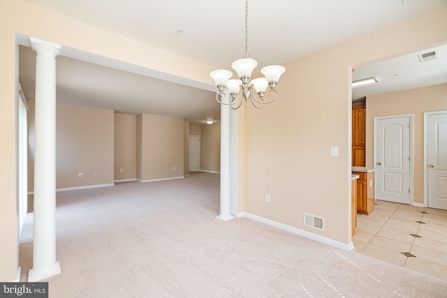 empty room with visible vents, baseboards, a chandelier, and light colored carpet