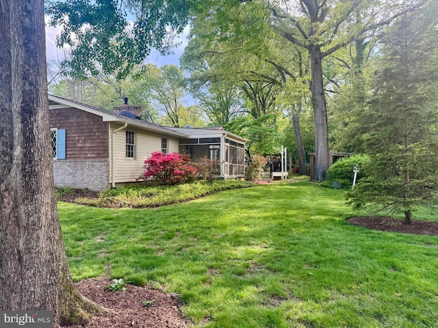 view of yard with a sunroom