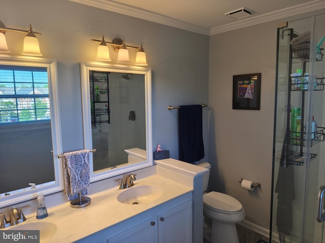 bathroom featuring toilet, a shower stall, and a sink