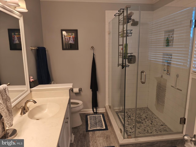 full bath with toilet, baseboards, a shower stall, and vanity