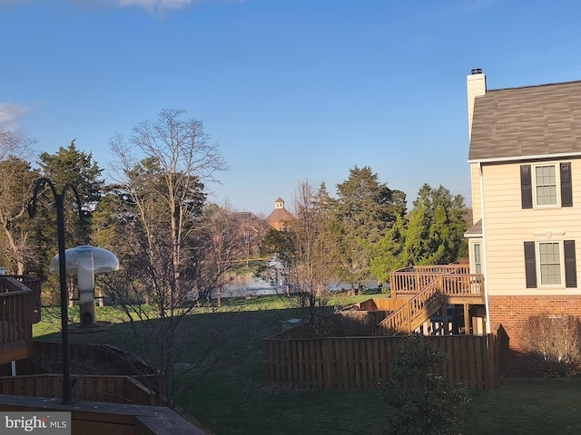 view of yard featuring fence, stairway, and a deck