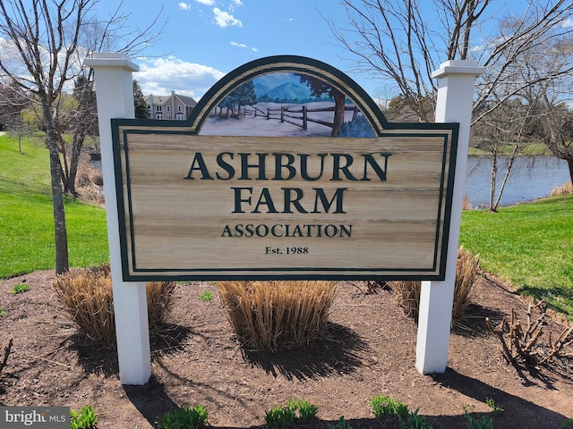 community sign featuring a water view