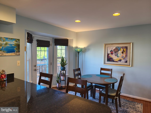 dining room with recessed lighting, baseboards, and wood finished floors