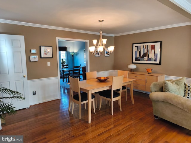 dining area featuring crown molding, a notable chandelier, and dark wood-style floors