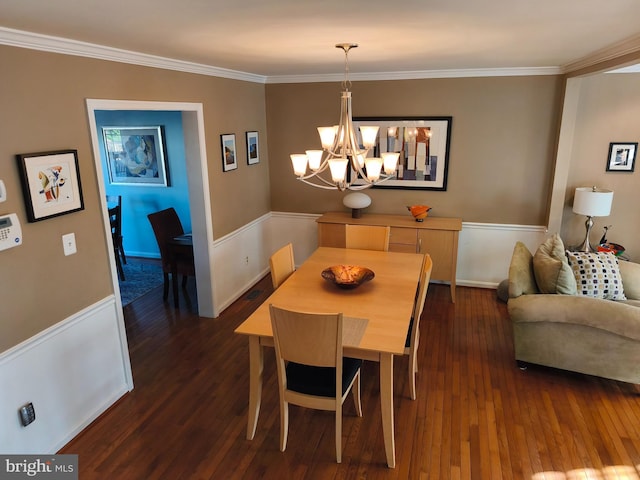 dining area with baseboards, ornamental molding, dark wood finished floors, and a chandelier