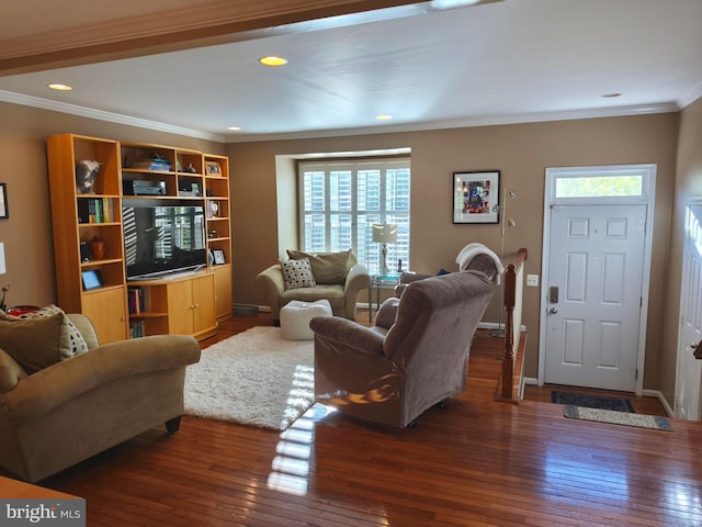 living room with baseboards, ornamental molding, a wealth of natural light, and hardwood / wood-style floors