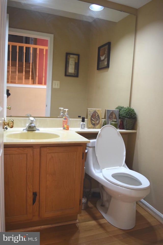 1716 Pebble Beach Dr, Bowie, MD 20721 - half bath with vanity, wood finished floors, and toilet