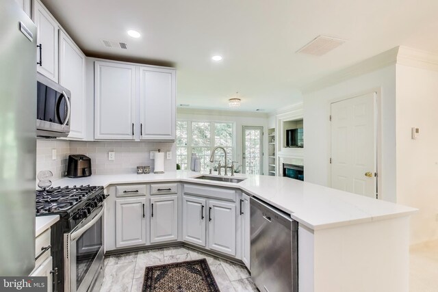 5922 Terrapin Pl Unit 5922, Alexandria, VA 22310 - kitchen with appliances with stainless steel finishes, a peninsula, light countertops, decorative backsplash, and white cabinetry