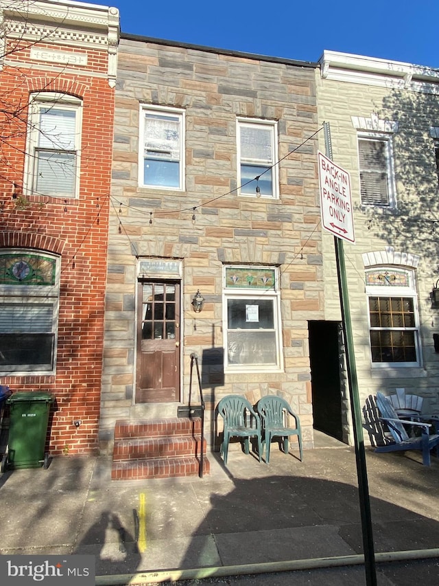 view of front of home with stone siding and entry steps