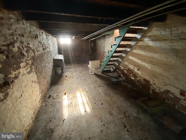 unfinished basement featuring stairs