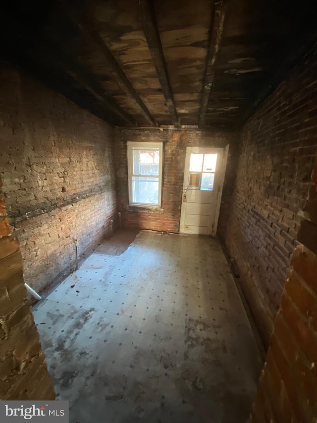 interior space featuring brick wall
