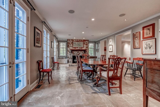 dining area with stone finish floor, recessed lighting, baseboards, visible vents, and ornamental molding