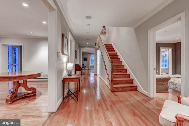entrance foyer with light wood-style floors, stairs, recessed lighting, baseboards, and a baseboard heating unit