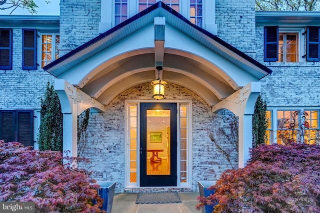 property entrance with brick siding