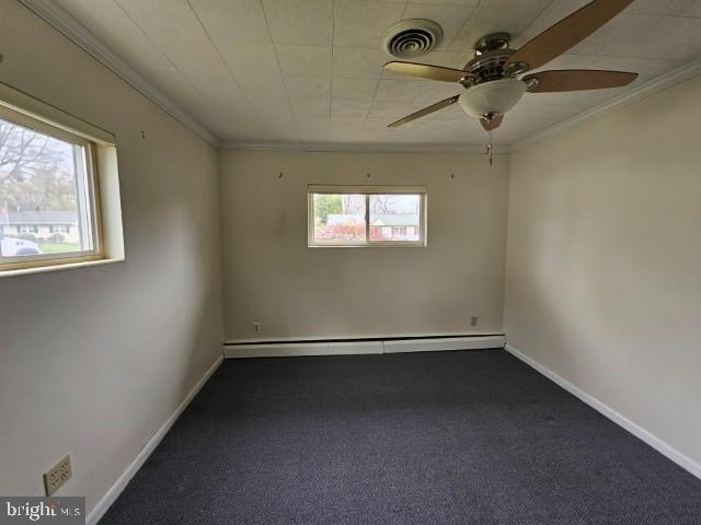 unfurnished room featuring a baseboard radiator, ornamental molding, ceiling fan, and visible vents