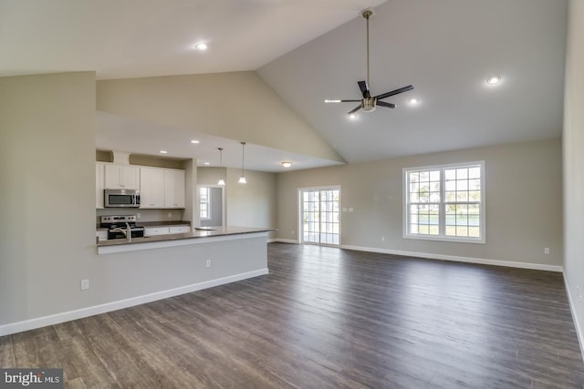 7826 Sugar Maple Dr, Milford, DE 19963 - unfurnished living room with baseboards, a ceiling fan, dark wood-style flooring, and high vaulted ceiling