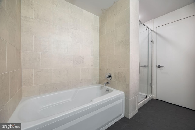 bathroom with a bath and a stall shower