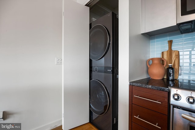 washroom with laundry area and stacked washer and dryer