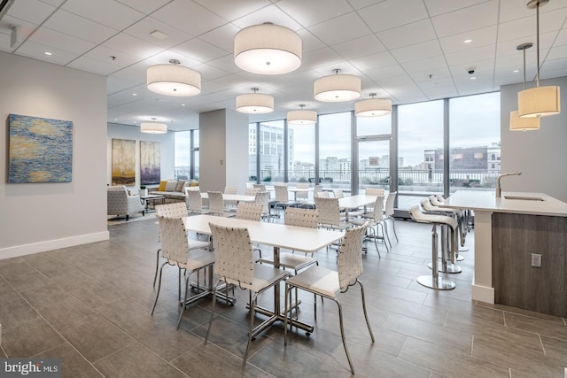 dining area featuring baseboards, a view of city, and dark wood-type flooring