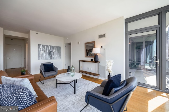 living area featuring visible vents and light wood finished floors