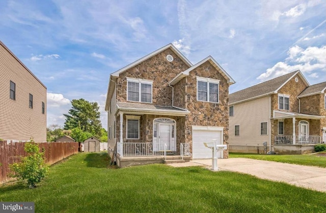 view of front of property with stone siding, a garage, a storage unit, a front yard, and a porch