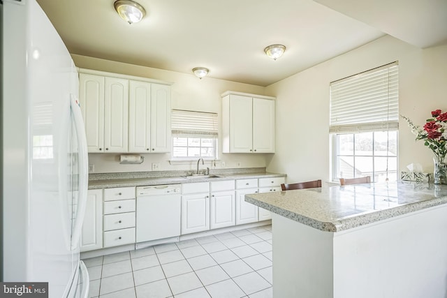 kitchen featuring a sink, white appliances, light tile patterned flooring, light countertops, and white cabinets
