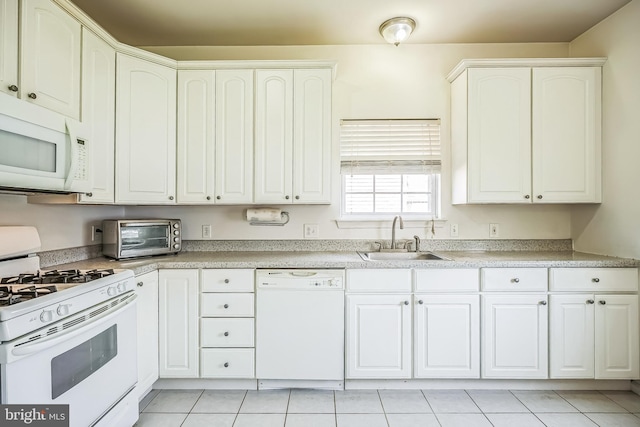 kitchen with a toaster, white appliances, a sink, light countertops, and white cabinets