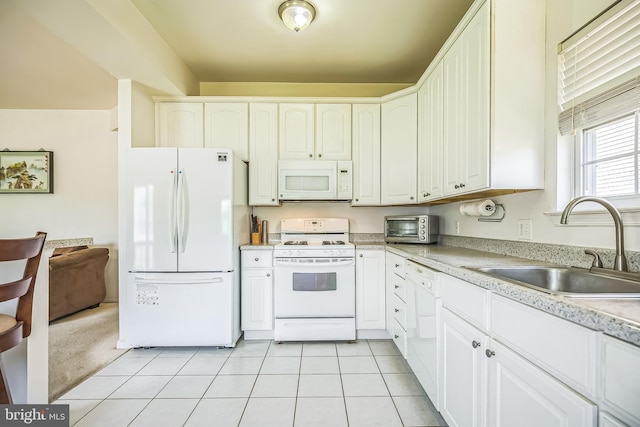 kitchen with a sink, a toaster, white cabinetry, white appliances, and light countertops