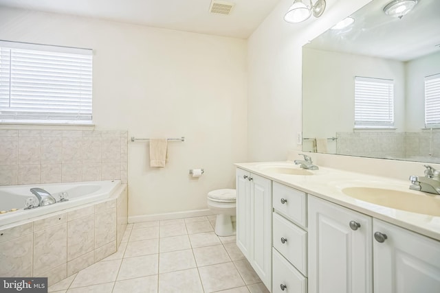 bathroom with tile patterned floors, a garden tub, visible vents, and a sink