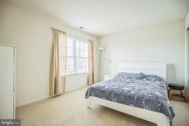 bedroom featuring visible vents, baseboards, and carpet floors