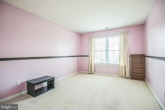 carpeted spare room with baseboards and visible vents