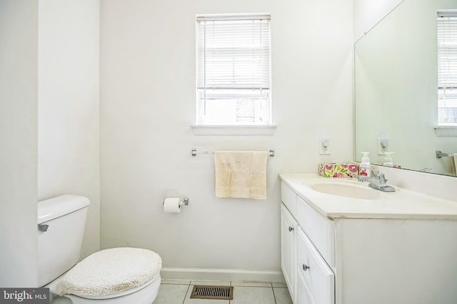 bathroom featuring a healthy amount of sunlight, toilet, visible vents, and tile patterned floors