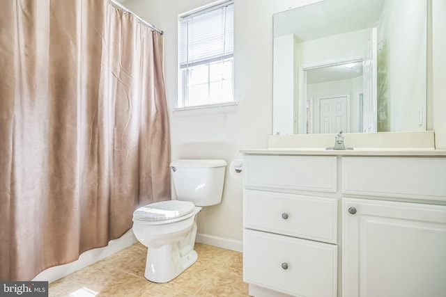 bathroom with toilet, baseboards, curtained shower, tile patterned flooring, and vanity