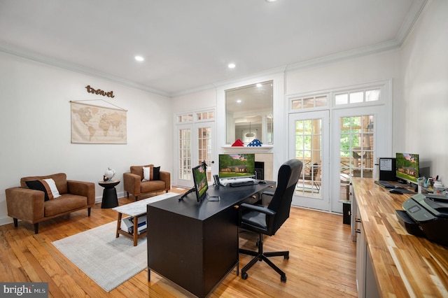home office featuring crown molding, french doors, recessed lighting, and light wood-style flooring