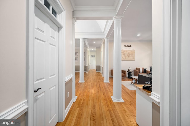 hall featuring light wood-type flooring, baseboards, ornate columns, ornamental molding, and recessed lighting