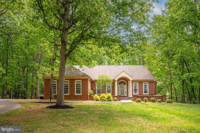 ranch-style house with brick siding and a front yard