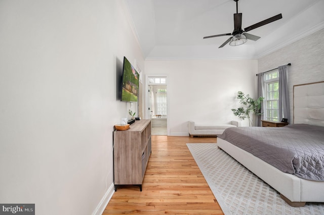 bedroom with crown molding, baseboards, and light wood-type flooring